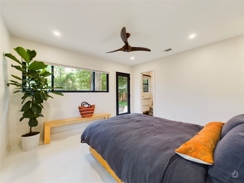 6007 Leisure Run Road Austin, TX 78745 - Photo 10 of 26 a bedroom with a bed and a potted plant