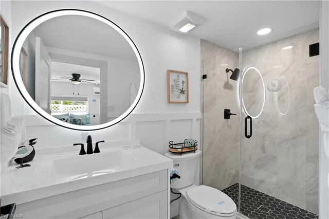 a bathroom with a sink a toilet and a mirror