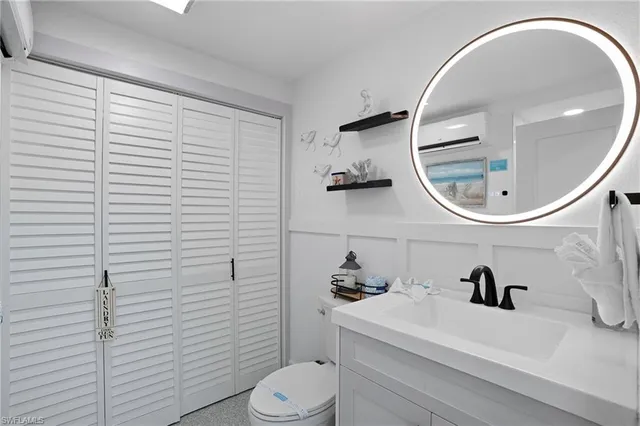 a bathroom with a sink a toilet and a mirror