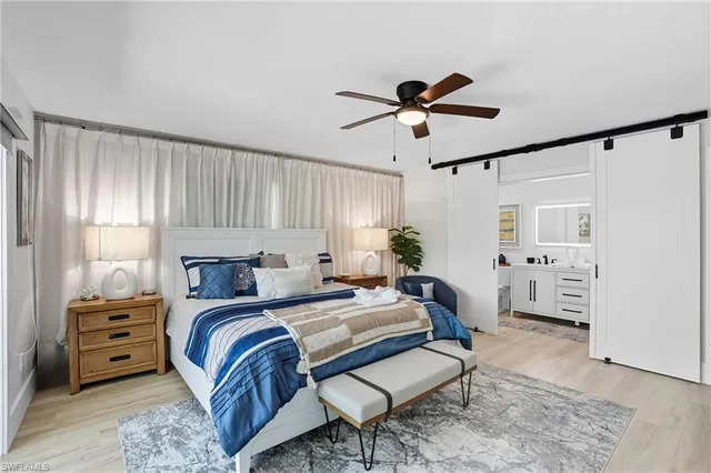 a bedroom with a bed a couch and a window