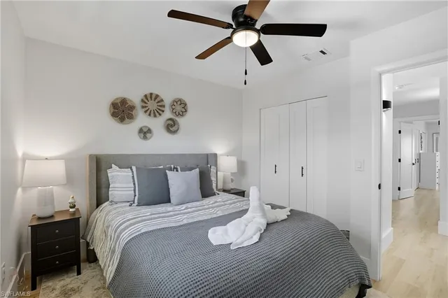 a bedroom with a bed and a chandelier