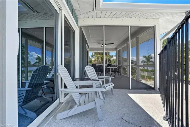 a swimming pool with outdoor seating and yard