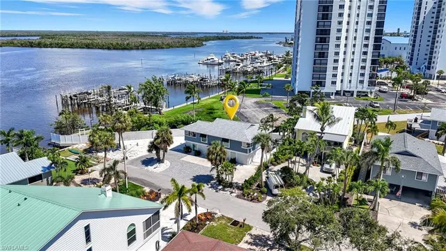 an aerial view of a house with a garden and lake view