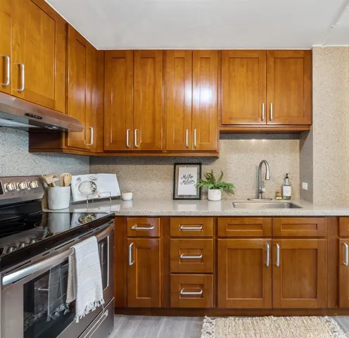 a kitchen with granite countertop cabinets stainless steel appliances and wooden cabinets