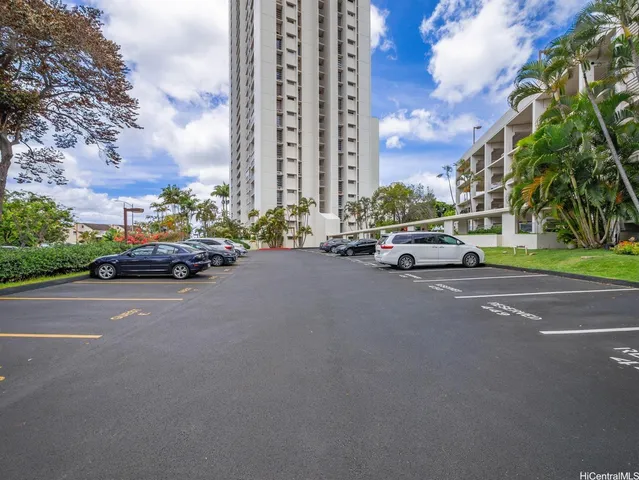 a view of parking garage with cars parked