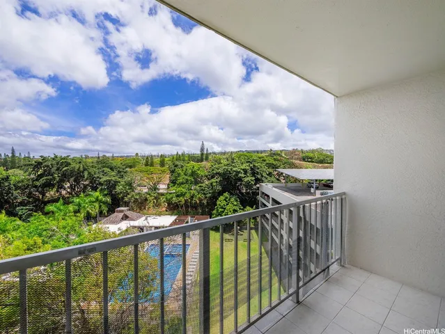 a view of balcony with wooden floor and fence