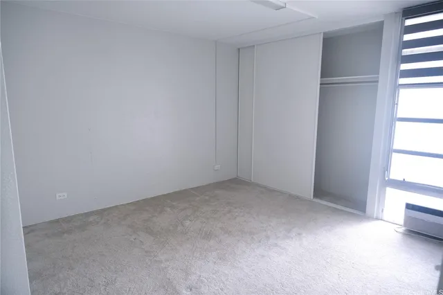 a view of an empty room with a window