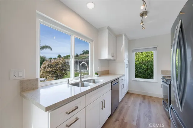 a kitchen with a sink stove and refrigerator