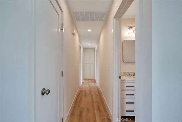 a view of a hallway with wooden floor