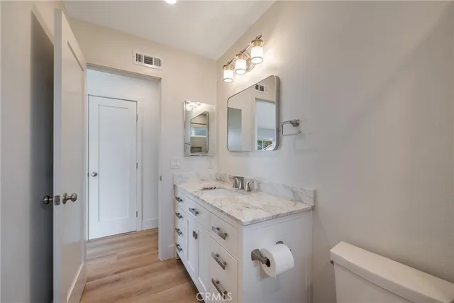 a bathroom with a sink a toilet and a mirror