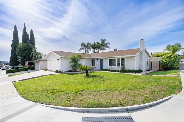 a view of a house with a porch and a garden