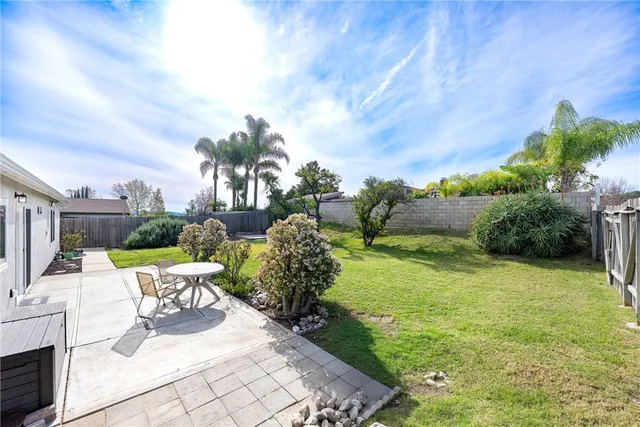 a view of a patio with furniture and garden