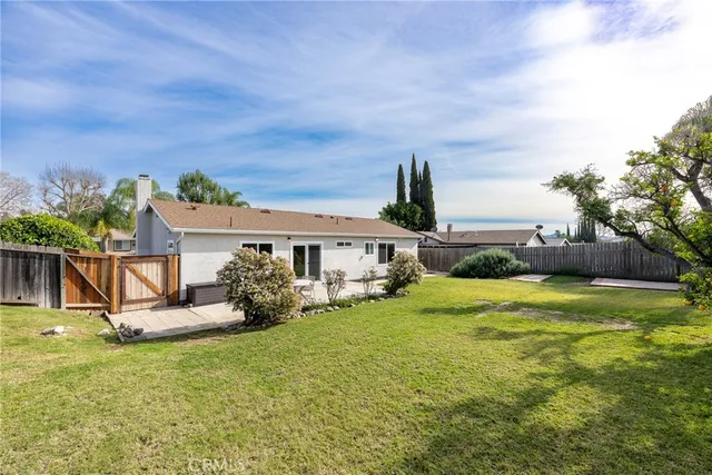 a front view of house with outdoor seating and barbeque oven