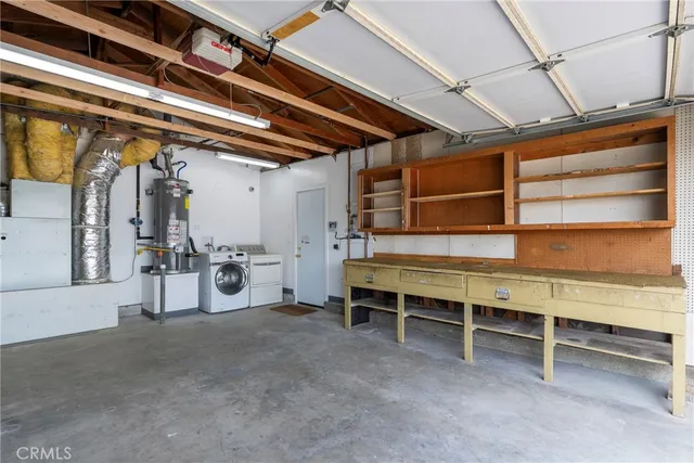 a view of an empty room with furniture and a window