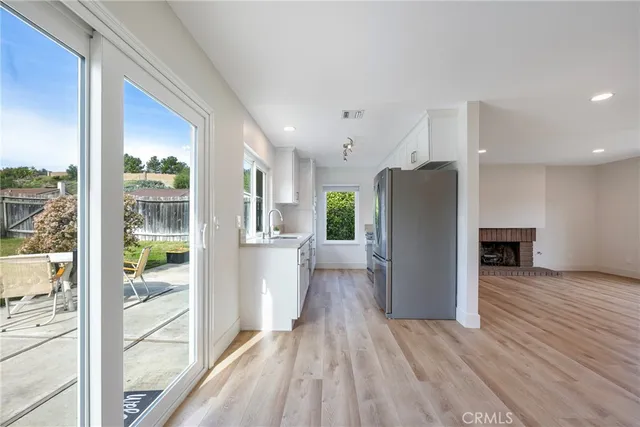 a view of kitchen with furniture and refrigerator