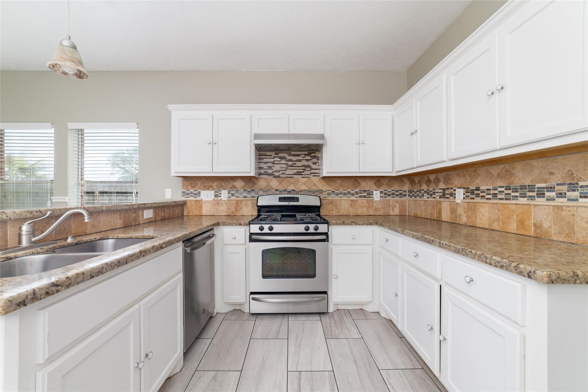 6315 Laurel Run Houston, TX 77084 - Photo 5 of 9 a kitchen with granite countertop white cabinets and white appliances