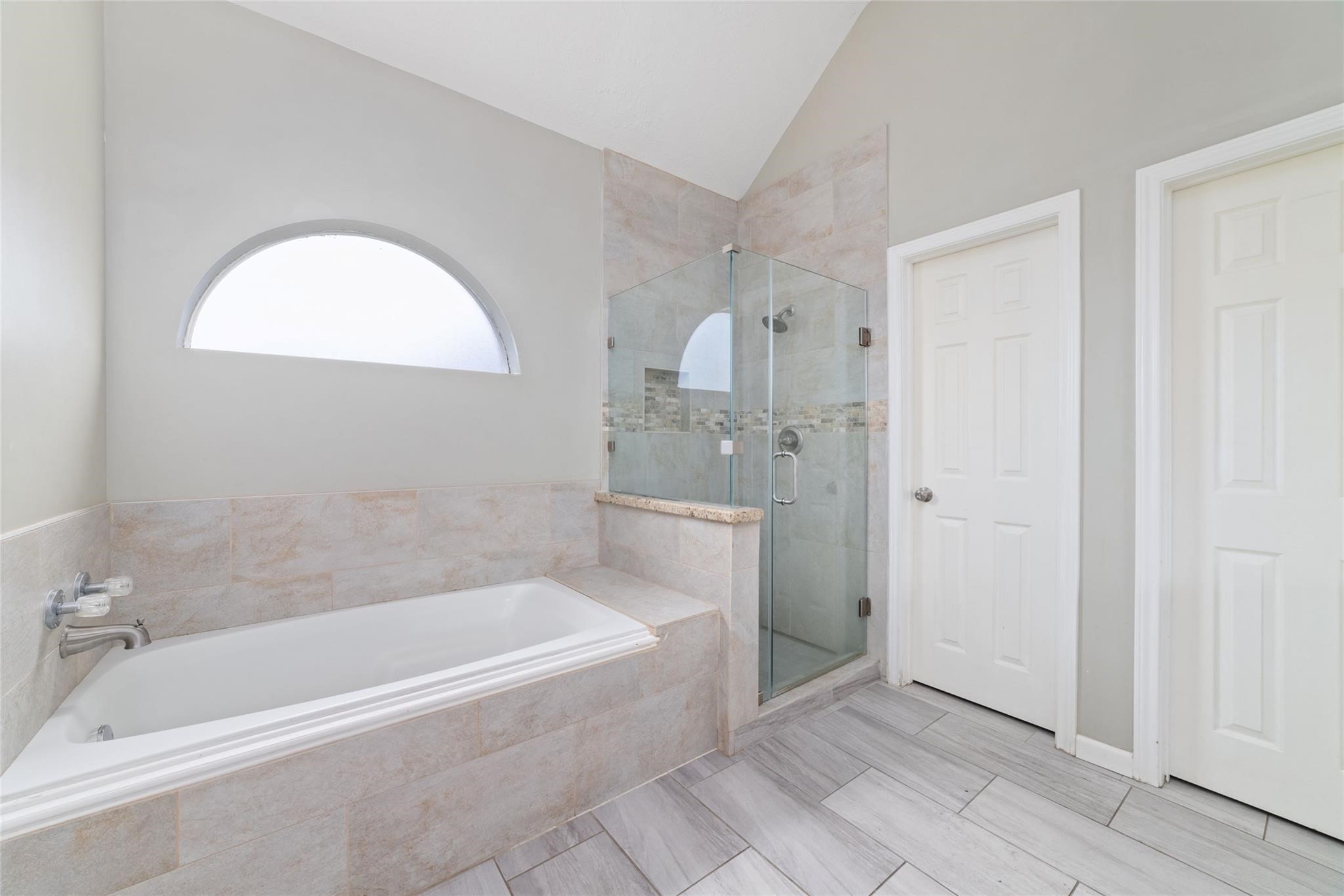 6315 Laurel Run Houston, TX 77084 - Photo 6 of 9 a spacious bathroom with a bathtub and a shower