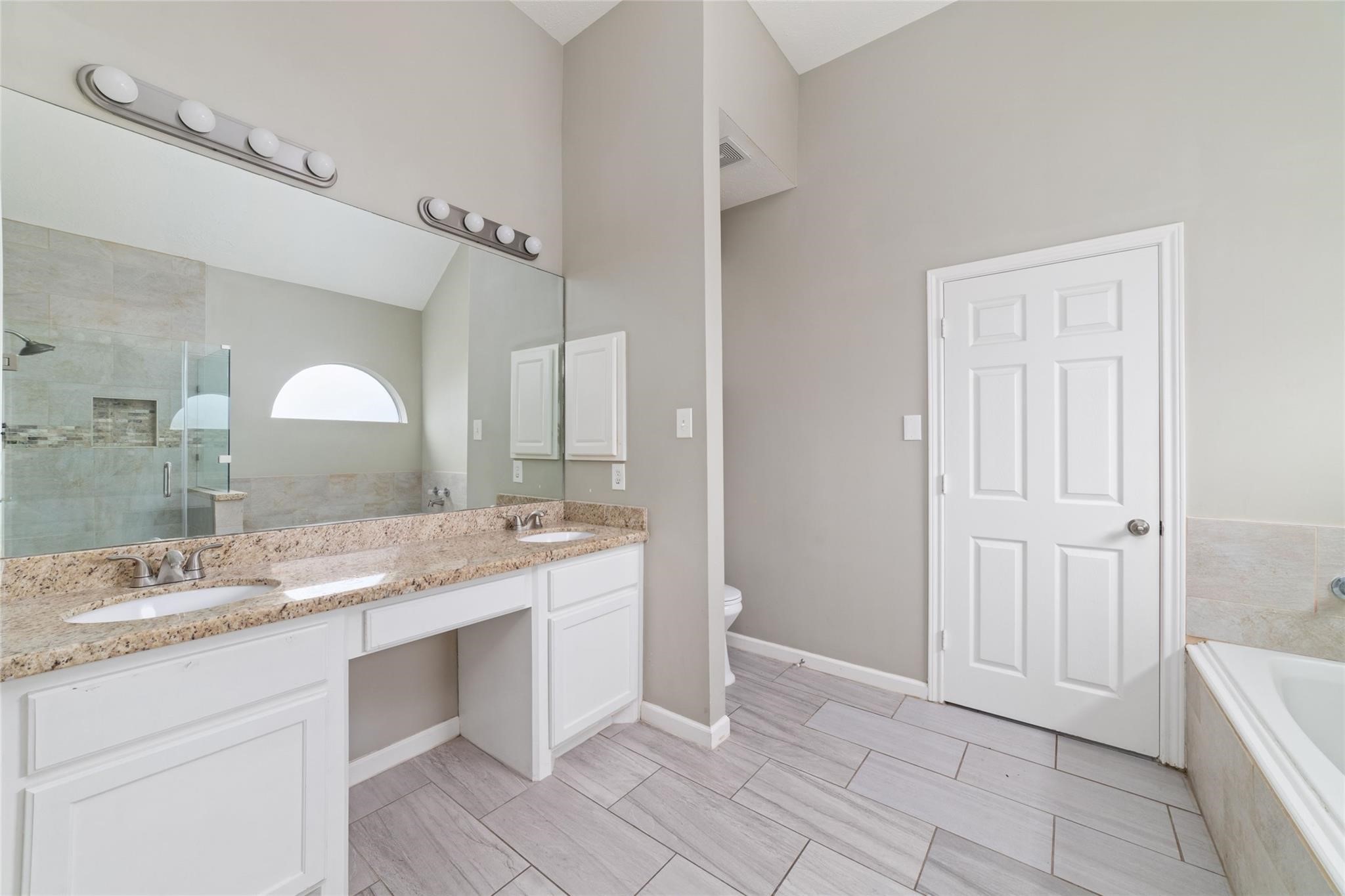 6315 Laurel Run Houston, TX 77084 - Photo 7 of 9 a bathroom with a granite countertop sink and a mirror