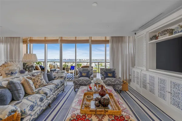 a living room with furniture a rug and a large window