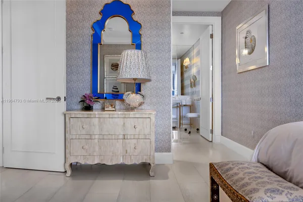 a bedroom with two beds and a chandelier