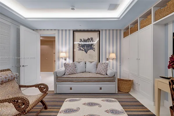 a bedroom with a bed and a flat screen tv on dresser