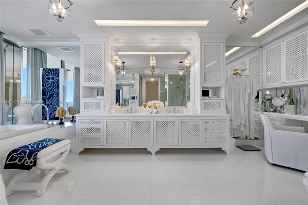 a bathroom with a double vanity sink a mirror a bathtub and shower