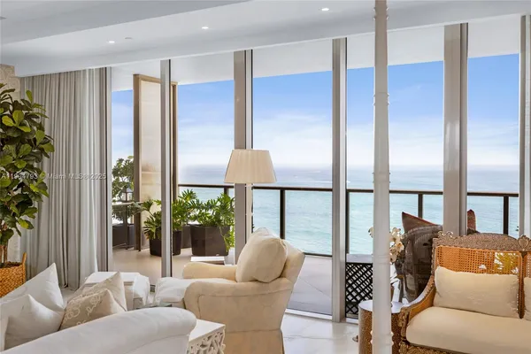 a living room with furniture and a floor to ceiling window