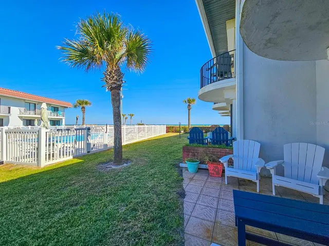 a view of a chair and table in the garden
