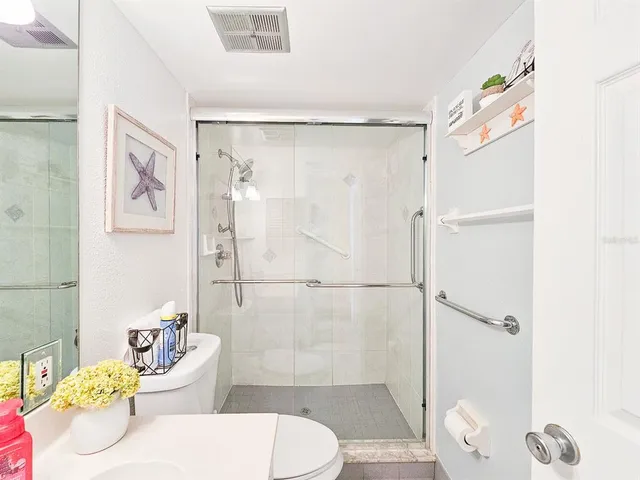 a bathroom with a sink toilet and shower