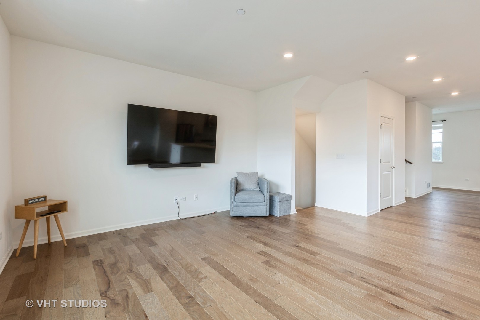 2950 Reflection Drive Naperville, IL 60564 - Photo 6 of 17 a view of a livingroom with wooden floor and a flat screen tv