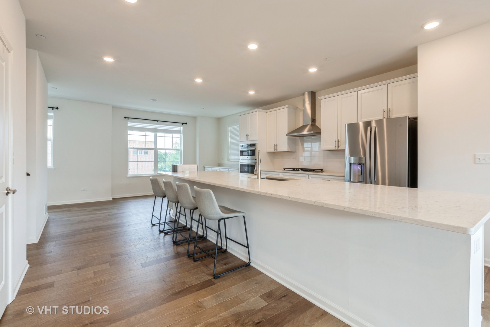 2950 Reflection Drive Naperville, IL 60564 - Photo 7 of 17 a kitchen with stainless steel appliances granite countertop a refrigerator a sink a stove and white cabinets with wooden floor
