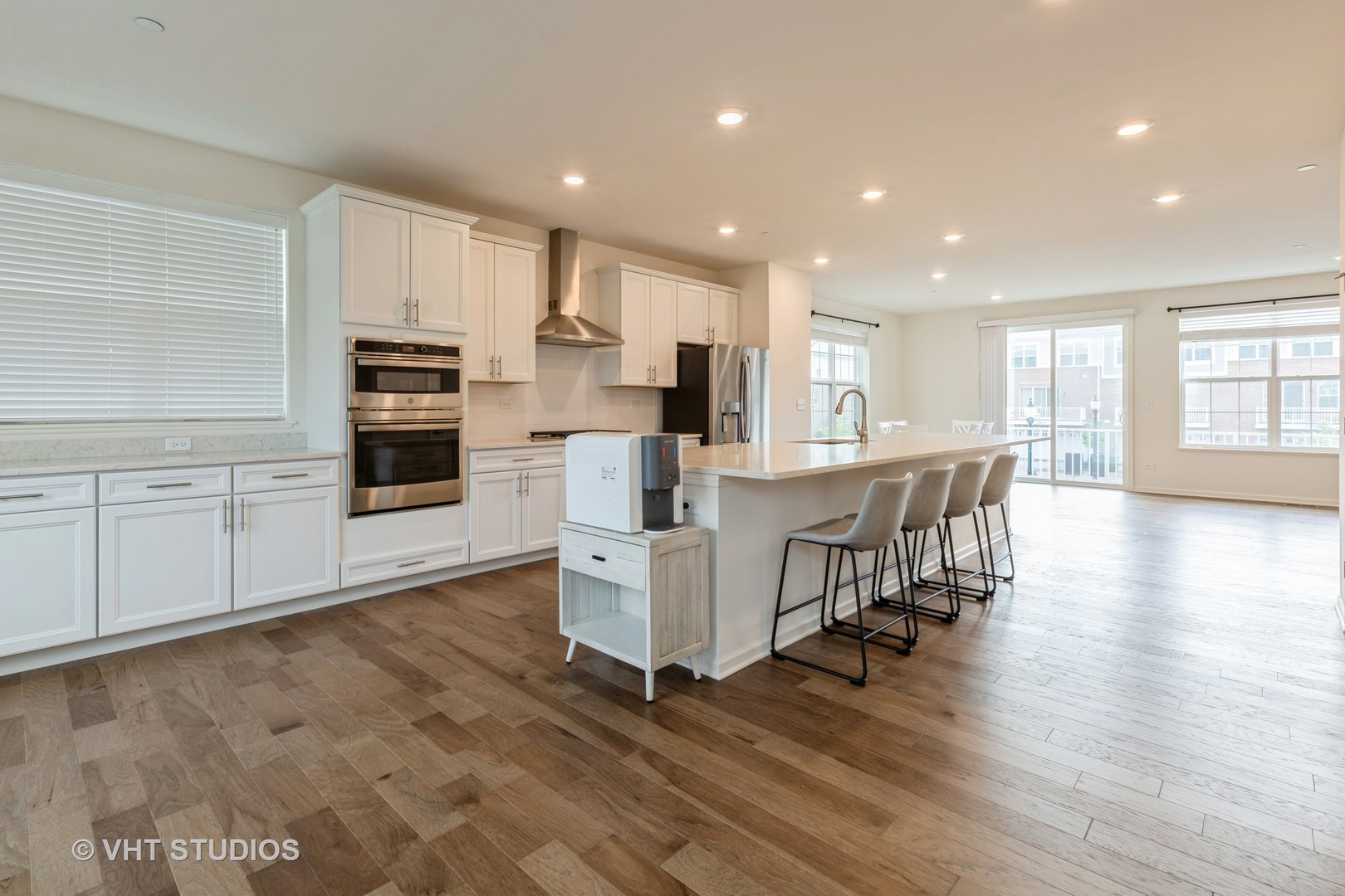 2950 Reflection Drive Naperville, IL 60564 - Photo 9 of 17 a kitchen with stainless steel appliances kitchen island granite countertop a stove top oven a sink a refrigerator with white cabinets and wooden floor