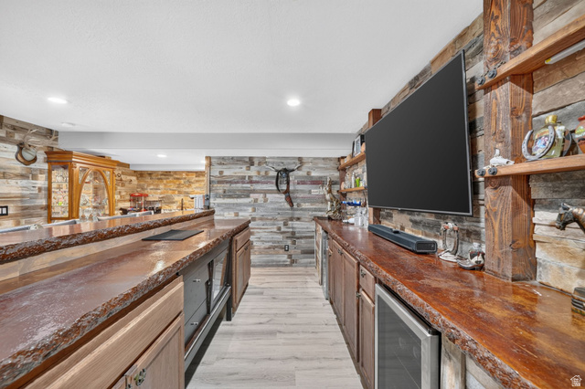 3644 Spiral Springs Road Tooele, UT 84074 - Photo 22 of 41 Custom wet bar with live-edge wood countertops, integrated beverage refrigerators, recessed lighting, and wood-finish flooring
