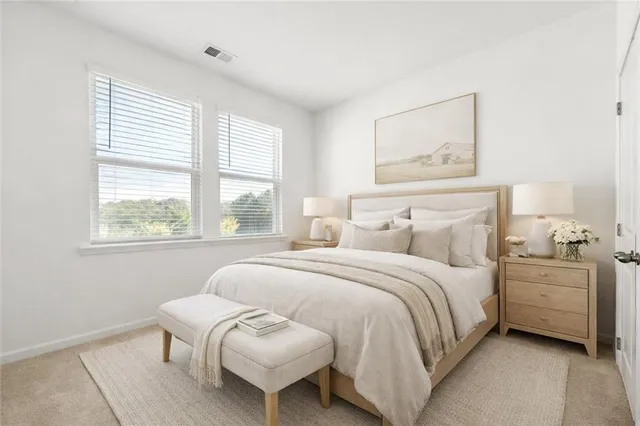 a bedroom with a bed and a large window