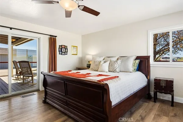 a bedroom with bed and wooden floor