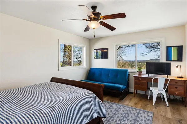 a bedroom with a bed a couch and a window