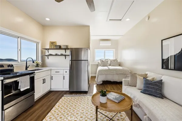 a kitchen with stainless steel appliances white cabinets and a refrigerator