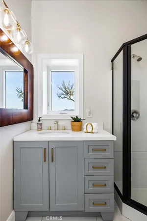 a kitchen with stainless steel appliances granite countertop a stove a sink and a refrigerator with wooden floor