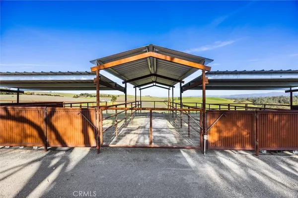 a view of a roof deck with wooden floor and a floor to ceiling window
