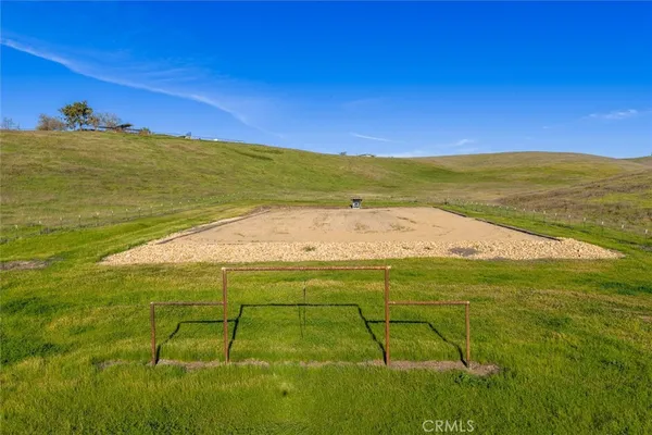 a wooden bench sitting in the middle of a field