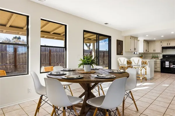 a kitchen with stainless steel appliances granite countertop a stove top oven a sink and white cabinets