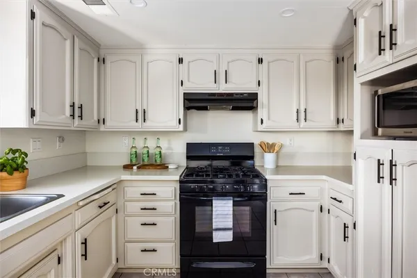 a bedroom with a bed and painting on the wall