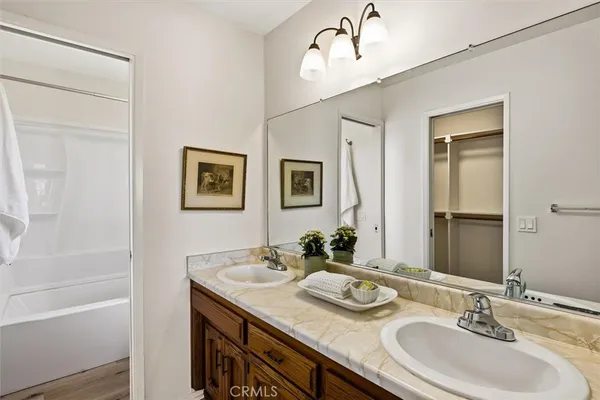 a bathroom with double vanity sinks and a mirror