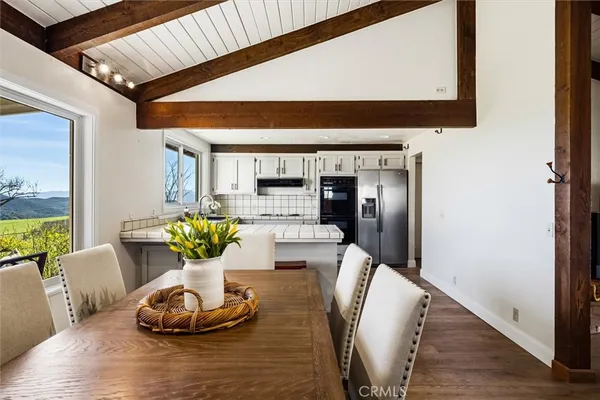 a dining room with furniture and wooden floor