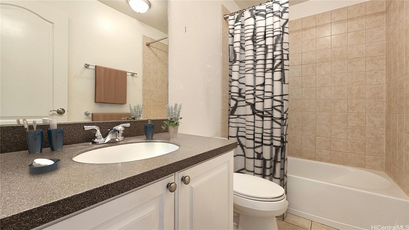 92-1490 Ali'inui Drive, Unit 803 Kapolei, HI 96707 - Photo 13 of 20 a bathroom with a granite countertop sink toilet and shower