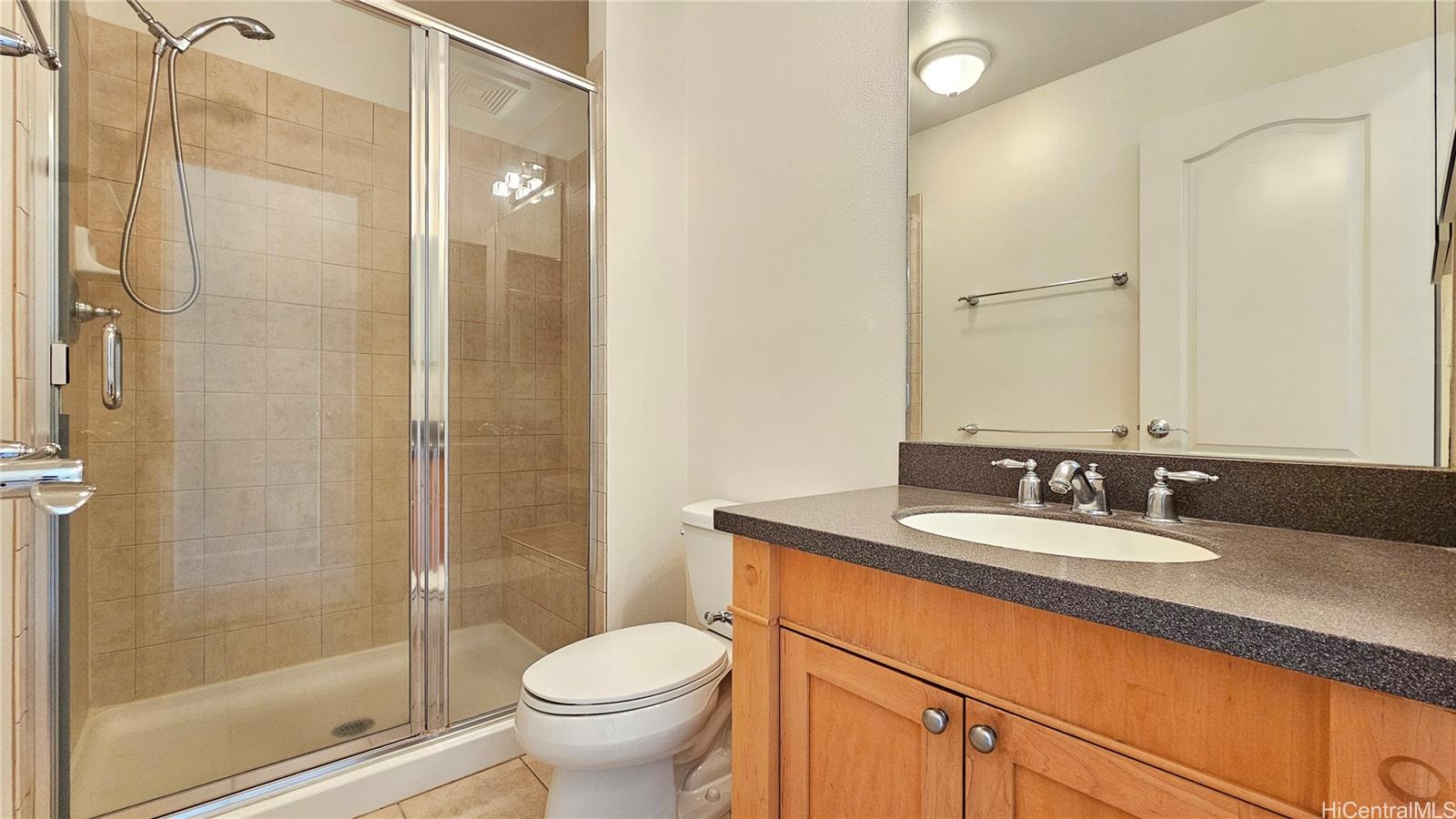 92-1490 Ali'inui Drive, Unit 803 Kapolei, HI 96707 - Photo 14 of 20 a bathroom with a granite countertop sink toilet and shower