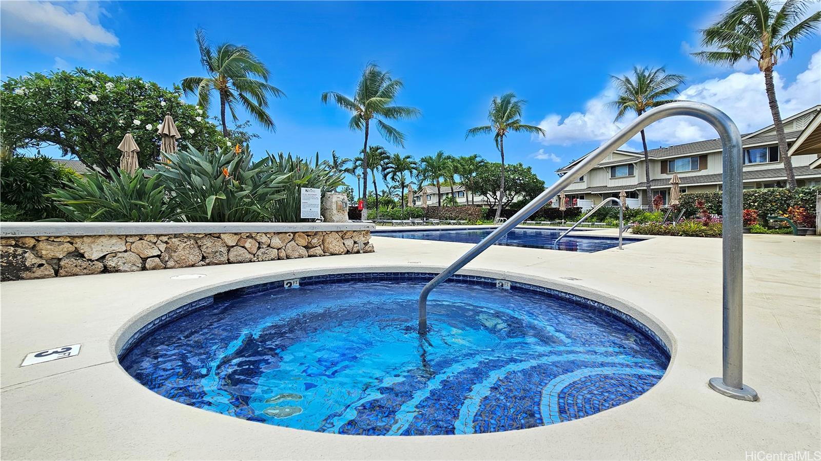 92-1490 Ali'inui Drive, Unit 803 Kapolei, HI 96707 - Photo 17 of 20 a view of a swimming pool with a house