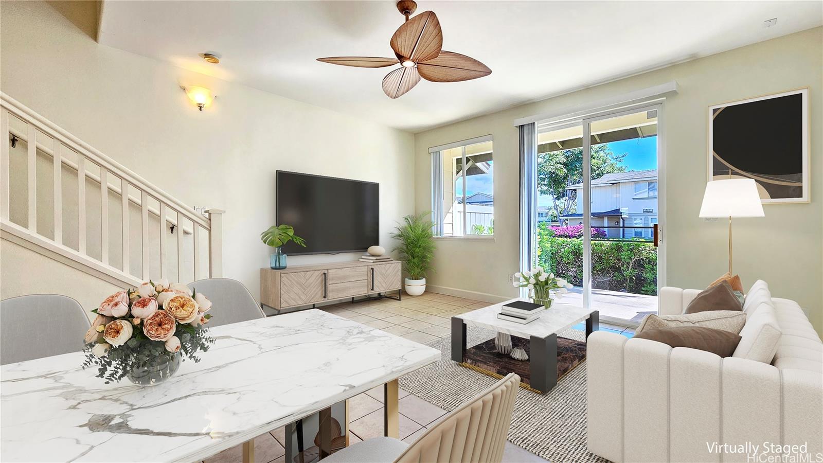 92-1490 Ali'inui Drive, Unit 803 Kapolei, HI 96707 - Photo 8 of 20 a living room with furniture a flat screen tv and a floor to ceiling window