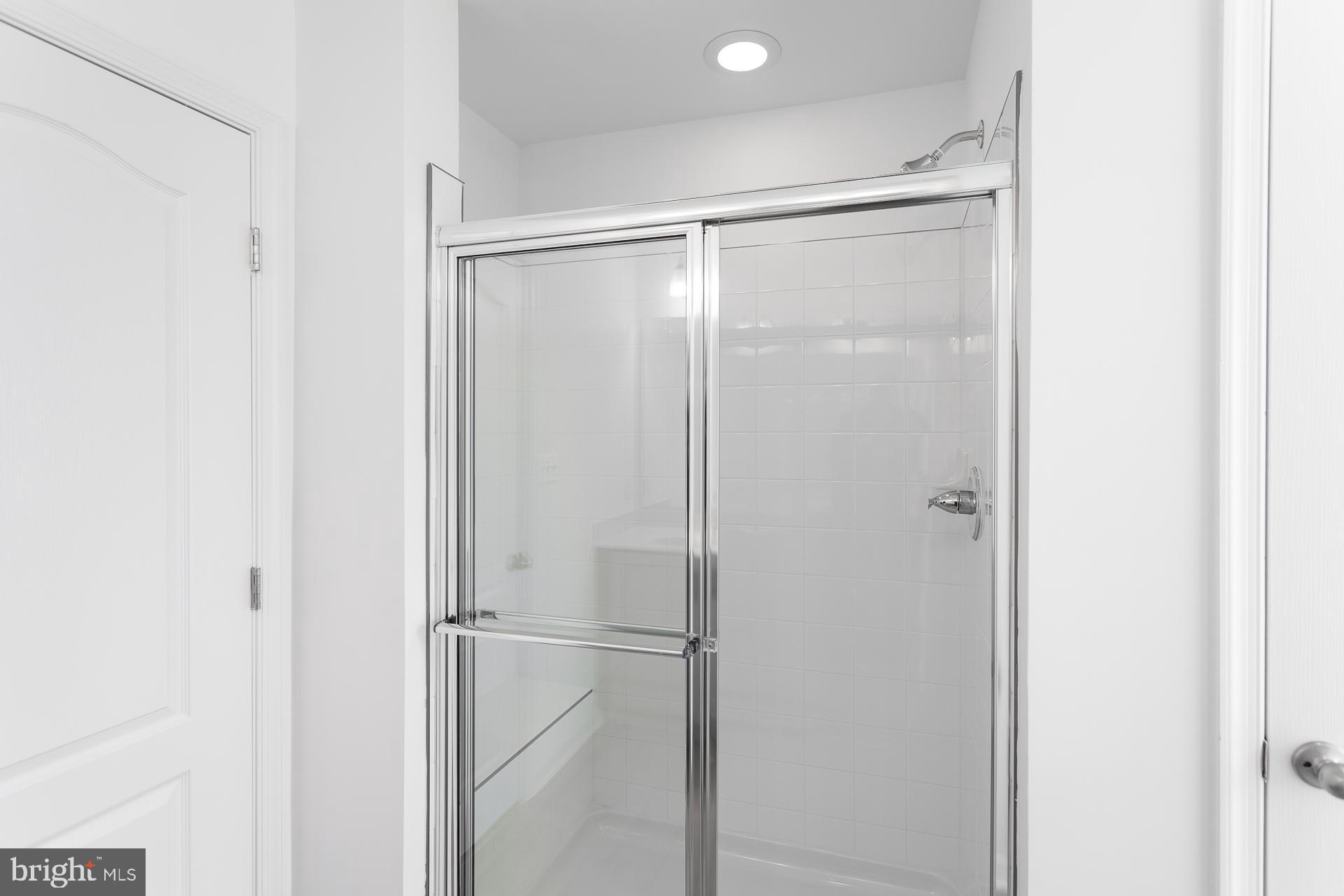 139 Spool Road Inwood, WV 25428 - Photo 25 of 34 a bathroom with a glass shower door