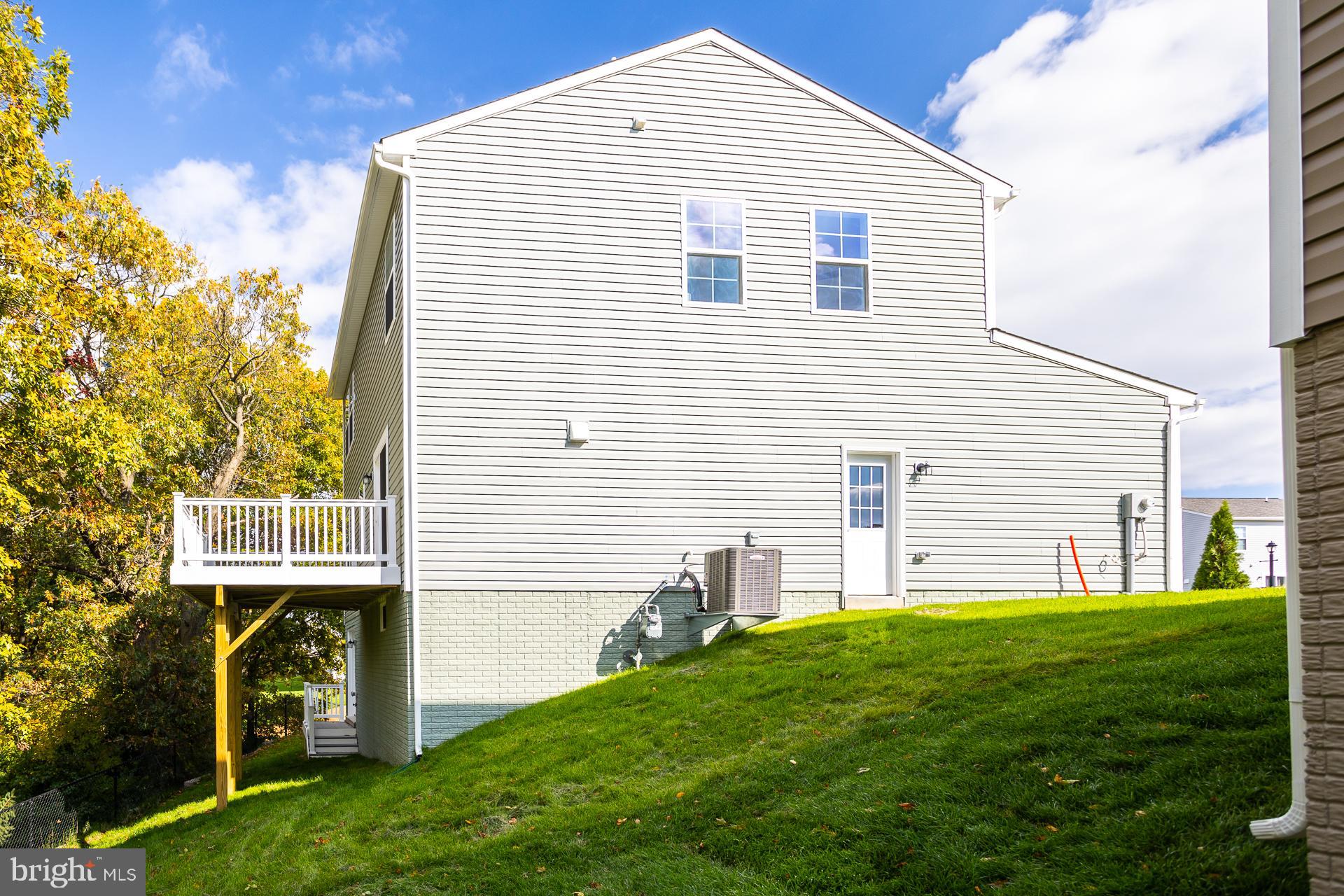 139 Spool Road Inwood, WV 25428 - Photo 27 of 34 a front view of a house with a yard and garage
